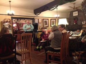 In photo. The scene is in the large open lobby of the inn. Chairs are set up wherever we can arrange them and some folks are sitting in a corner parlor area on comfy couches and large cousioned chairs. End photo.