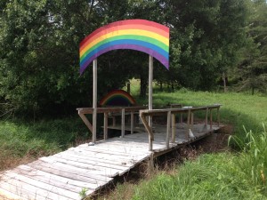 At the farm mentioned in the text, there is a grave yard for cherished animals and pets. The structure shown here is a low walking bridge with a rainbow portal above the path. A physical "Rainbow Bridge" entry way to the grave sites.