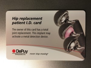 The wallet sized card displays 3 models of hip joint replacement hardware. The words are: "Hip replacement patient I. D. card. The owner of this card has a total joint replacement. This implant may activate a metal detection device. DePuy Orthopeadics, Inc."