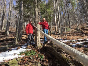In photo we see a rope line extending from the lower righthand corner of the photo to a tree about 25 feet away. There by the distant tree is Barry and Dan.