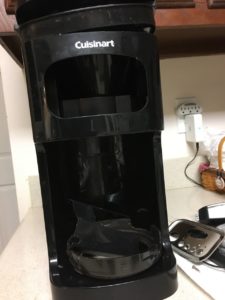 In photo is seen the empty plastic hulk that once held the electronics of the automatic coffee maker. The plastic is immediately recyclable while the electronics must be segregated to a mercury capture area first. Out of photo.