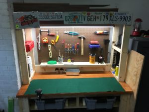 In photo: The working surface is protected with a durable felt pad and the backplane is fitted with tool holders for screwdrivers, small power tools, and heavy duty arts & crafts tools. out of photo.