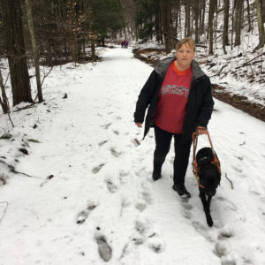 In photo. Tiffany and Quest hike on the logging road to the falls. Out of photo.
