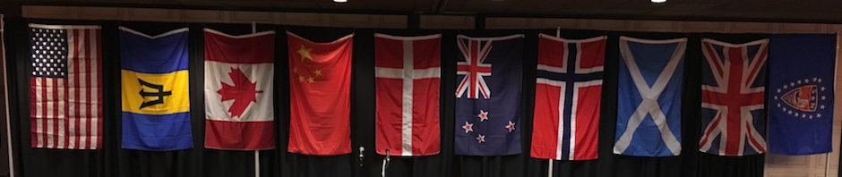 In photo. Our own flag is first and then follows alphabetically Barbados, Canada, China, Denmark, New Zealand, Norway, Scotland, and United Kingdom. The last flag on the right is the Sons of Norway organization flag. Out of photo.